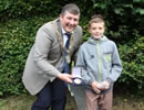ROM President skelping a boy through the hedge at Landheads